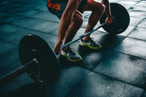 exercise pain man doing deadlift with weights