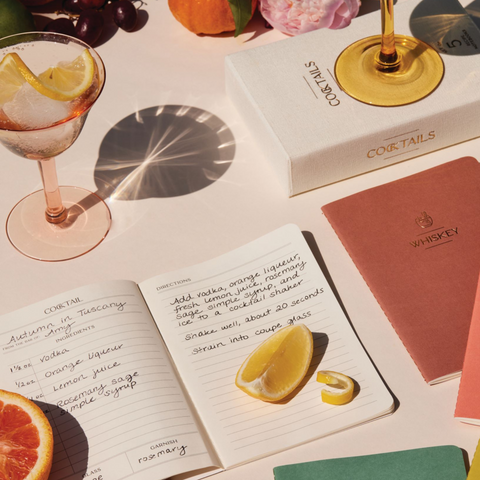 Cocktail Notebook Set with ingredients and cocktails surrounding it