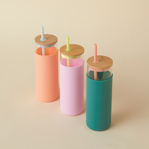 3 Glass Water Bottle with Straw on beige background