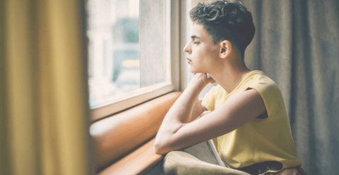 A young person looking out of a window, representing coming-of-age classics