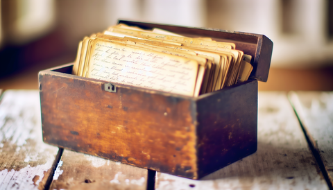 vintage recipe box with recipes on a wood table