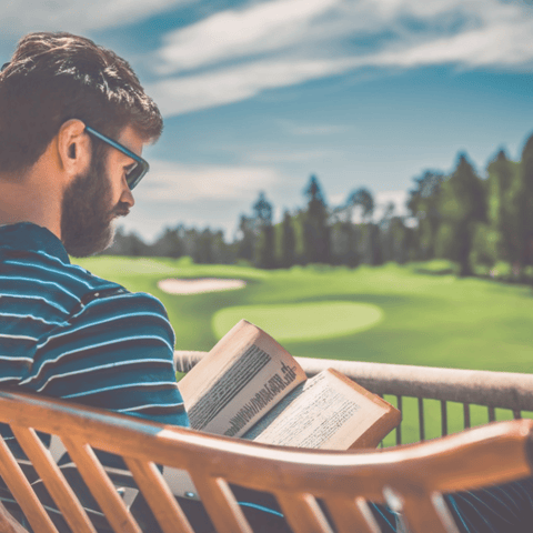 person reading vintage golf book