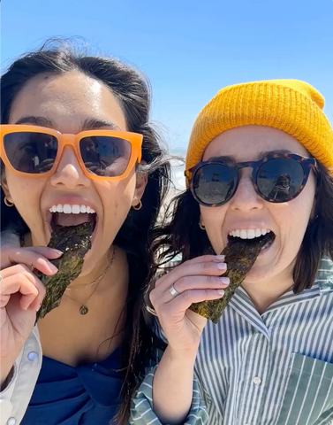 Two people eating and enjoying Gimme seaweed snacks