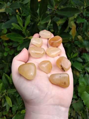 Yellow aventurine stones in hand