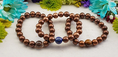 Copper bead bracelets with gemstones on display