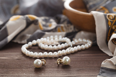 Pearl strands and earrings on table display