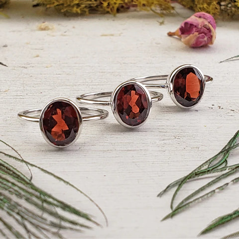 Image of three garnet sterling silver rings