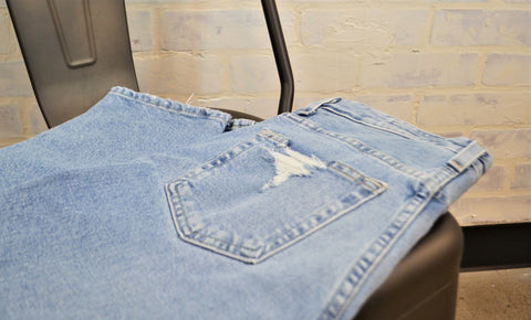 Distressed Denim jean back pocket