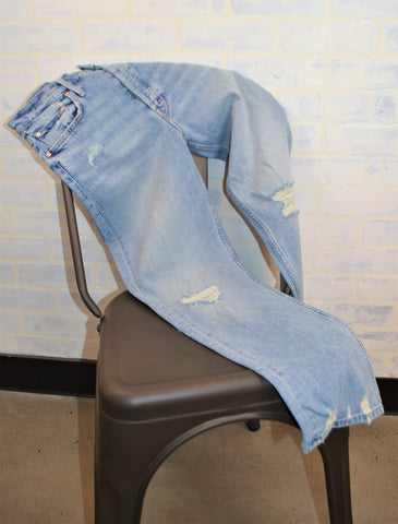 Distressed straight leg jeans on chair