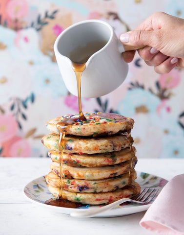 image of syrup pouring over cookie dough pancakes