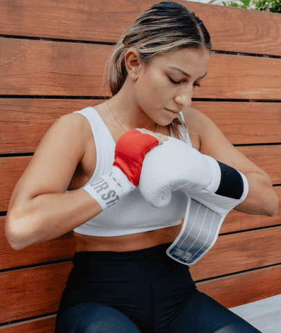 Female Putting On FightCamp Boxing Gloves