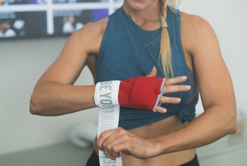 woman putting on boxing hand wraps