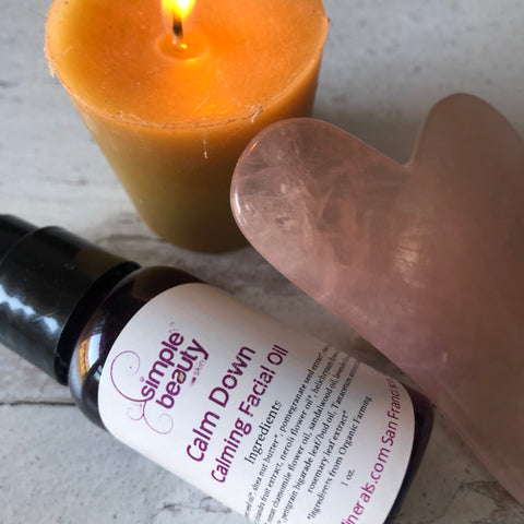 gua sha beauty stone calm down facial oil and beeswax candle 