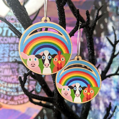 Cute animal earrings hanging on black glitter decor tree