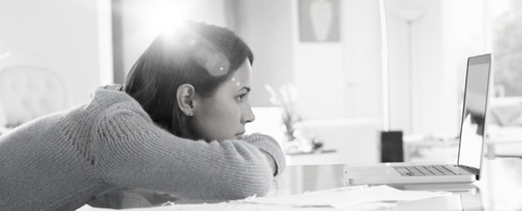 Woman leaning on desk