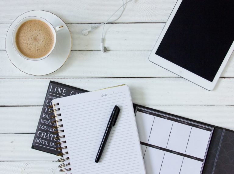 Coffee, notebook, Ipad, and pen for work