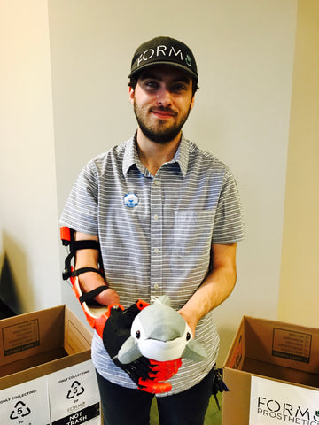 Aaron Westbrook of Form5 Prosthetics Inc. with Finn the Dolphin of Shore Buddies