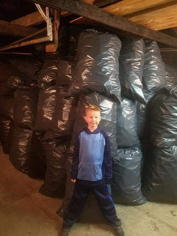 Orion Shearer in front of his trash collections