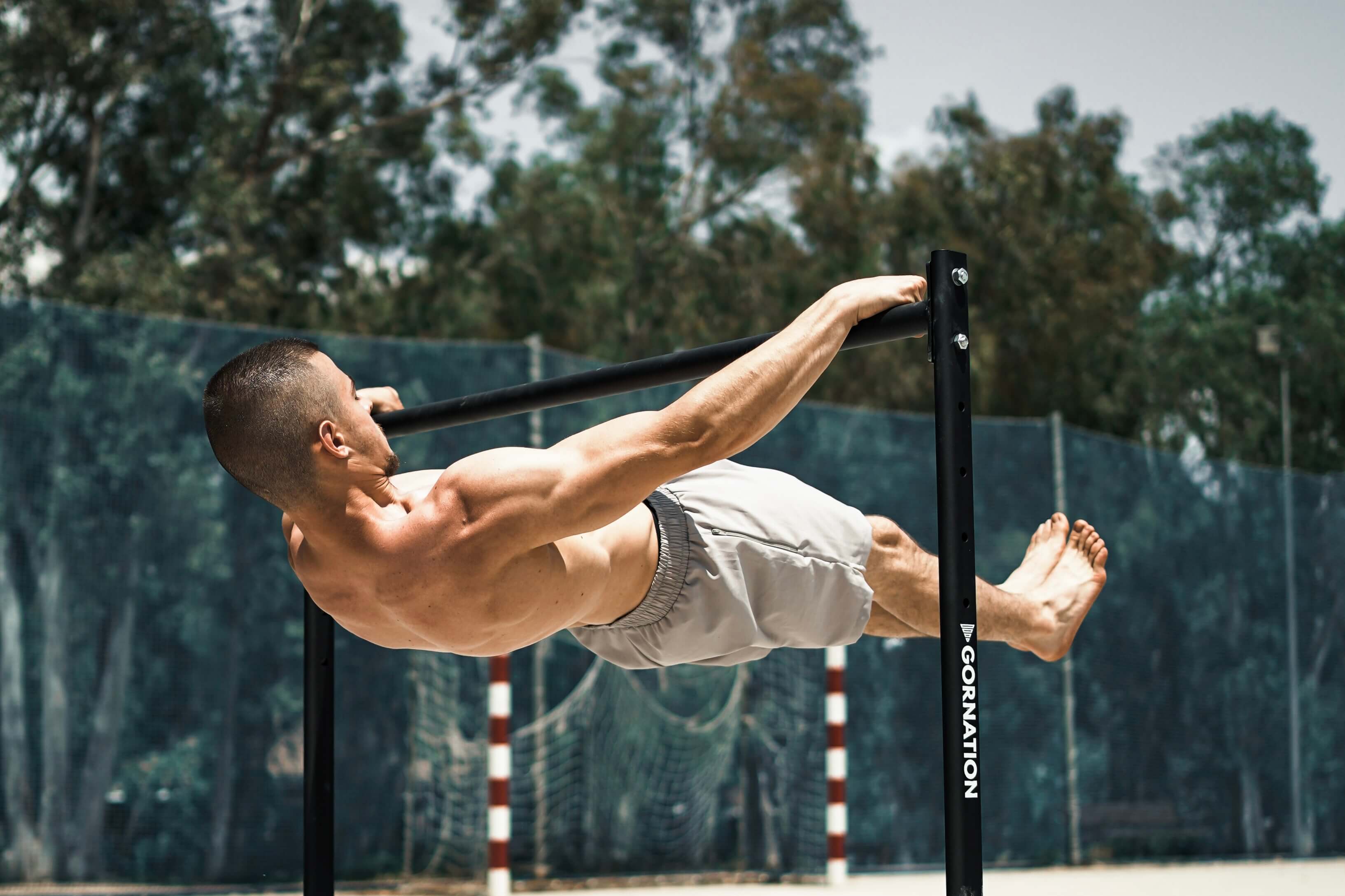 Calisthenics Athlete wearing a GORNATION Shorts performing a Front Lever on a Premium Static Bar by GORNATION