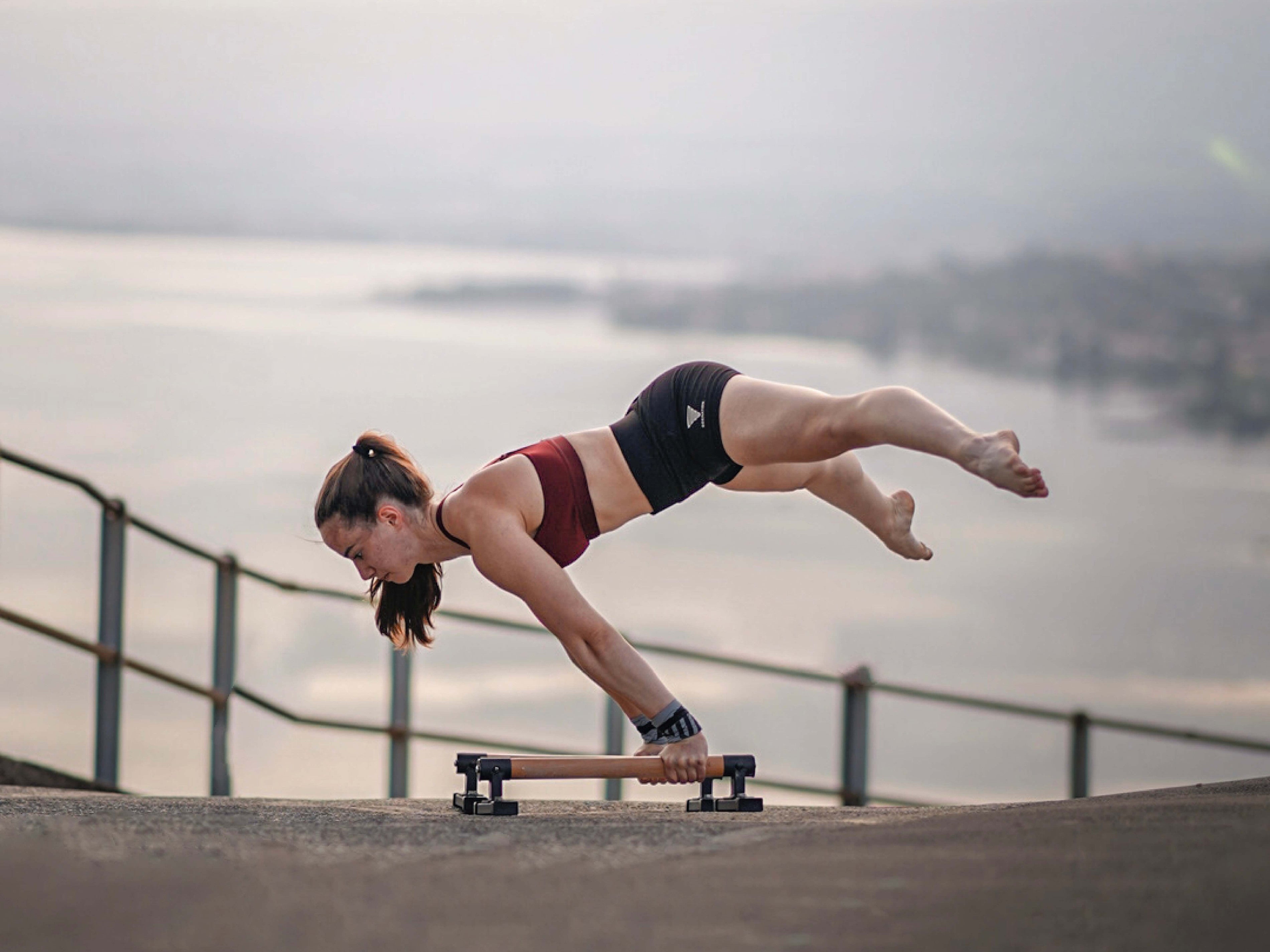 female calisthenics athlete lena limoli is doing planche