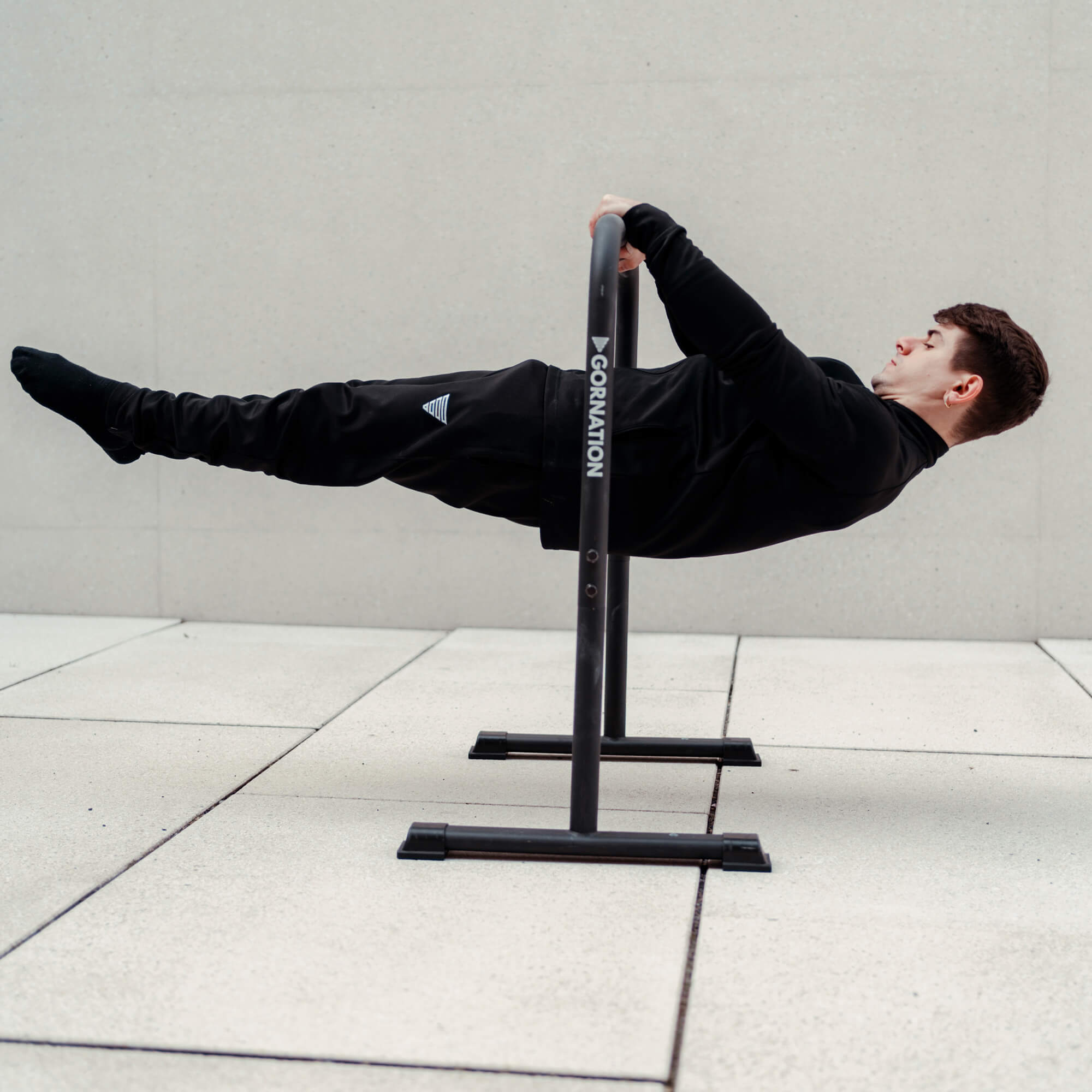 Exercise on dip bars high parallel bars front-lever