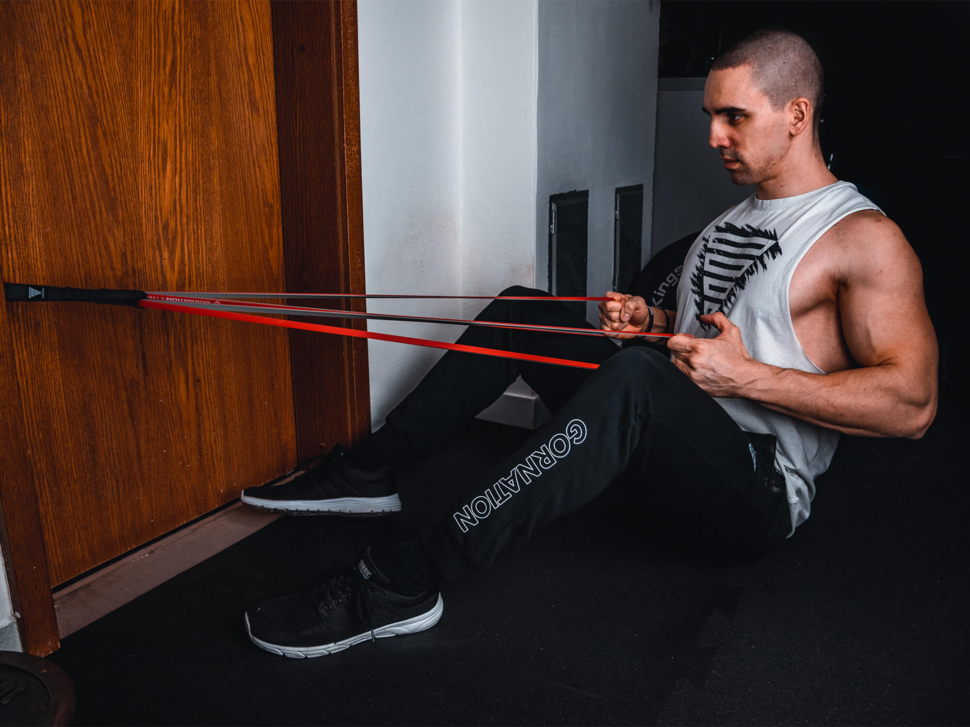 guy doing bodyweight rows with resistance band and door anchor