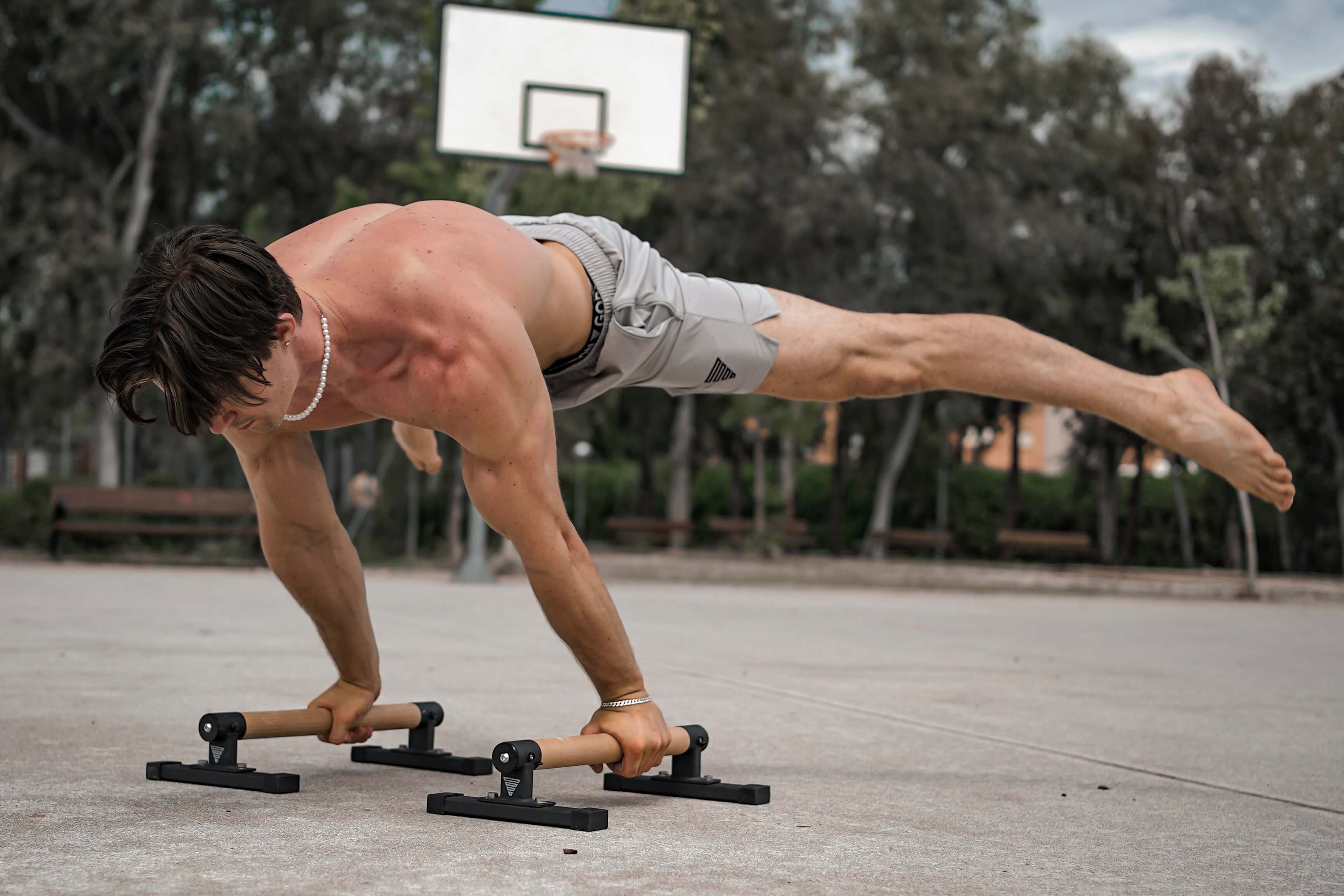 Calisthenics Athlete performing a Straddle Planche on Premium Parallettes Pro by GORNATION while wearing Shorts by GORNATION