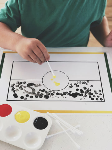 Little boy doing an Aboriginal Dot painting