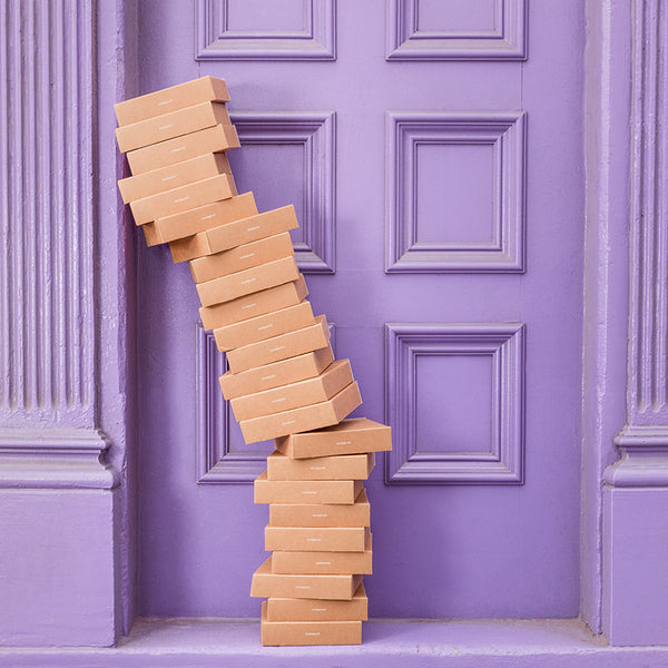 Kayser Lingerie cardboard packaging stacked in a doorway