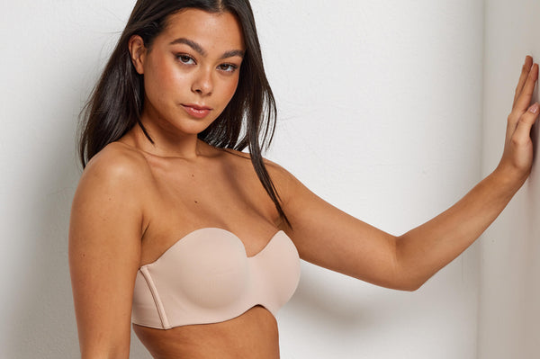 woman wearing a beige strapless bra that is perfect for travelling