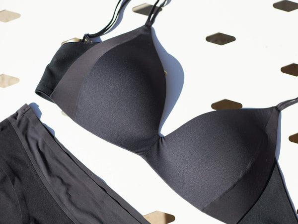 the dual wire free bra and brief laid out on a deck chair on a summers day