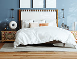 A styled bed in a blue background