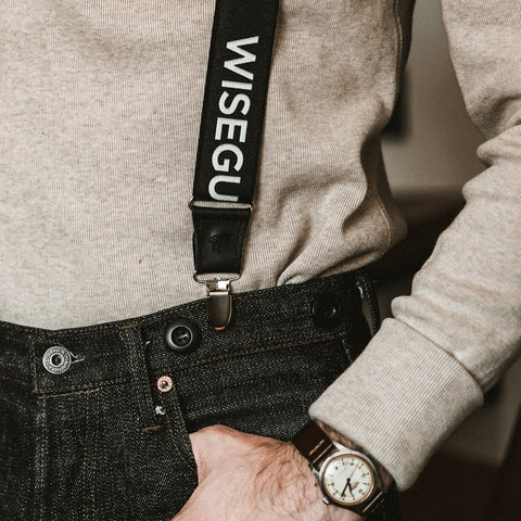 close up of man wearing suspenders with clips