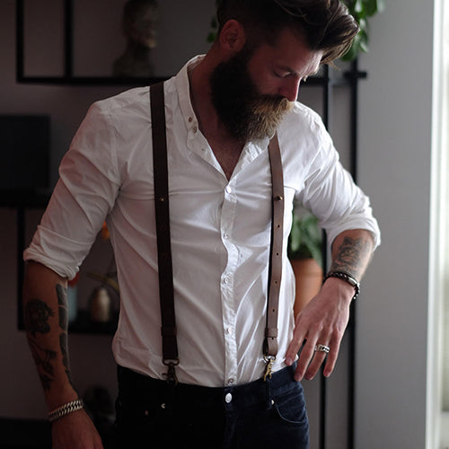 Man with button shirt, jeans and leather Wiseguy Suspenders
