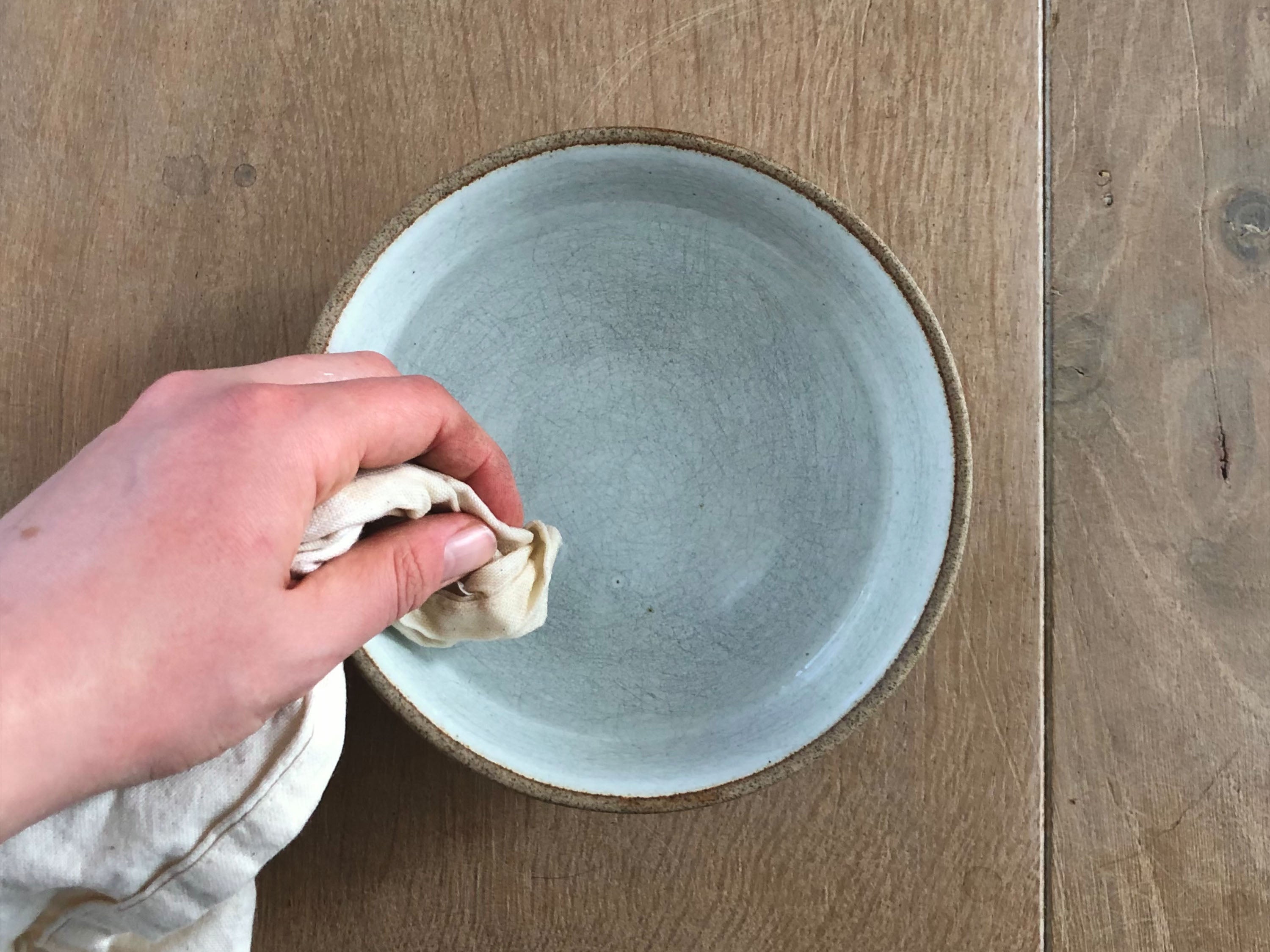 hand dipping towel in water