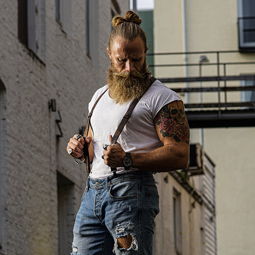 Man wearing a t-shirt, jeans and leather Wiseguy Suspenders