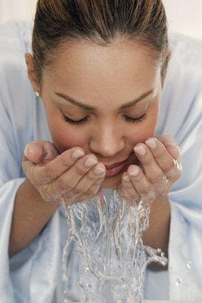 Gorgeous woman washing her face