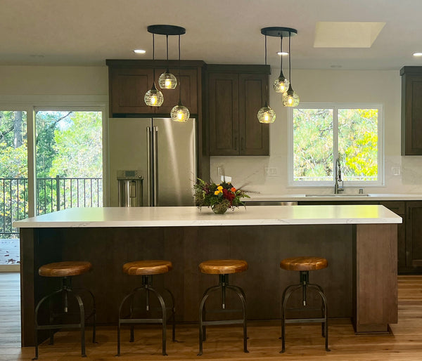 kitchen with two black light chandeliers featuring Bicycle Glass