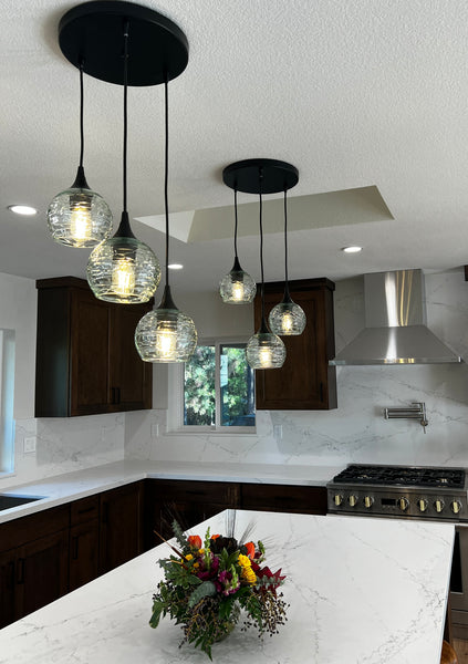 kitchen with two black light pendant chandeliers with recycled glass