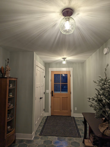 picture of two semi flush lights on hallway ceiling with lovely starburst shadows projected onto the ceiling