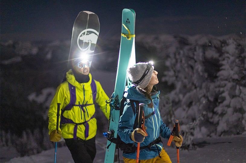 Skier and snowboarder using BioLite HeadLamp 800 Pro for backcountry skiing in the winter.