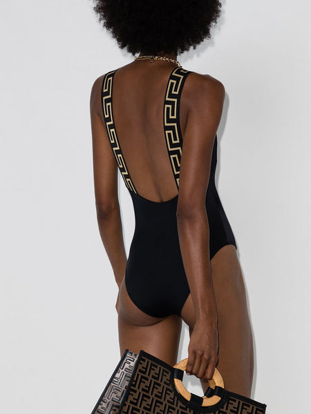   Make a splash in this Greca Key swimsuit from Versace. Designed with logo-detailed straps, this flattering one-piece is perfect for beach-side bathing and lively pool parties alike. Race you to the beach!  Made in Italy Highlights      black     recycled polyamide blend     signature Greca detailing     sleeveless     square neck     stretch-fit     Be mindful to try on swimwear over your own garments.     POSITIVELY CONSCIOUS: This Planet Conscious product is crafted from certified recycled or upcycled materials, which helps you make a better choice for the environment as they generate less energy, save water and reduce the need for new raw materials. For recycled synthetic clothing products we highly recommend using a microfibre-catching washing bag to ensure that no microplastics that can pollute water are released in the process.  Composition  Nylon 78%, Spandex/Elastane 22% Versace Greca Key swimsuit