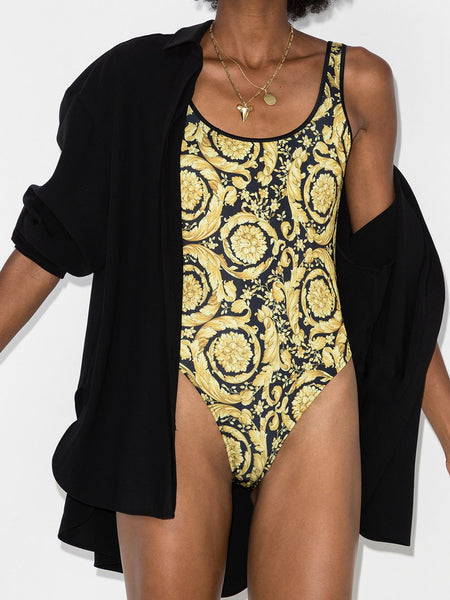   That's one way to make a statement. Nodding to the '90s, Versace's striking swimsuit is emblazoned with the brand's signature baroque print. Be bold. Highlights      gold/black      stretch-jersey   Versace baroque-print swimsuit  scoop neck     high cut     open back     baroque-pattern print  Made in Italy