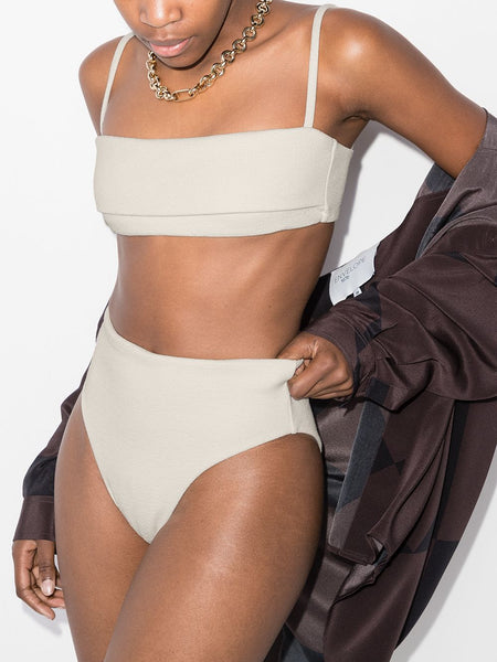 St. Agni x Ziah 90s high-waisted bikini bottoms Inspired by classic '90s silhouettes, these bikini bottoms feature a high-cut leg and a high-rise at the waist. Presented in a white colourway, this piece speaks to both Ziah’s and St. Agni's minimalist aesthetic.