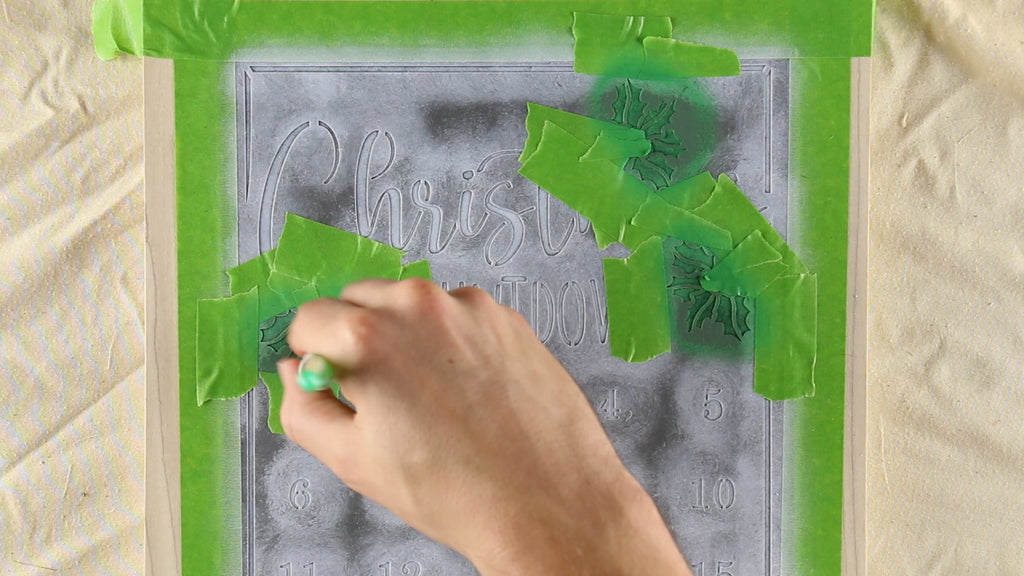 Then mask off and stencil your holly leaves