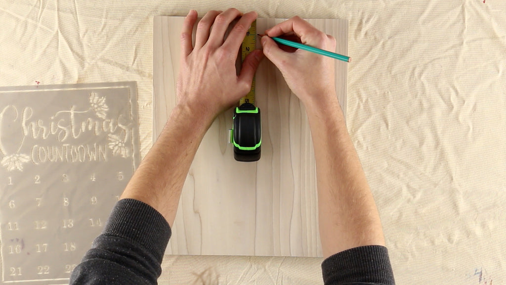 Use a pencil to make small dots along the top and side of the wood