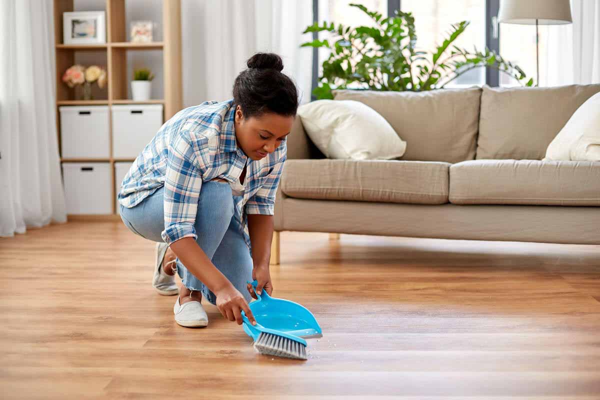 woman sweeping to prevent common indoor allergies