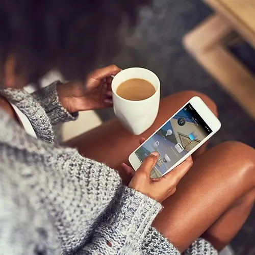 Woman with Control4 smart home app and tea