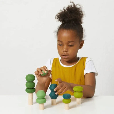 Child playing with stacking toy