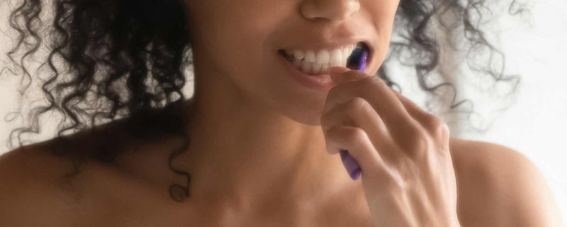 African American female brushing teeth